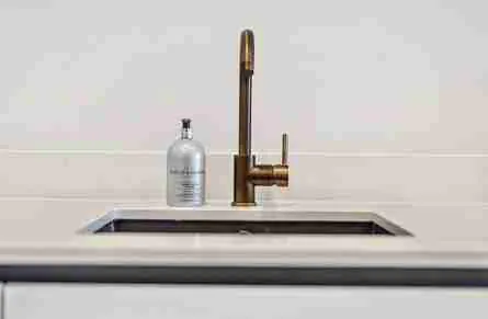 White worktop with sink and rose gold tap