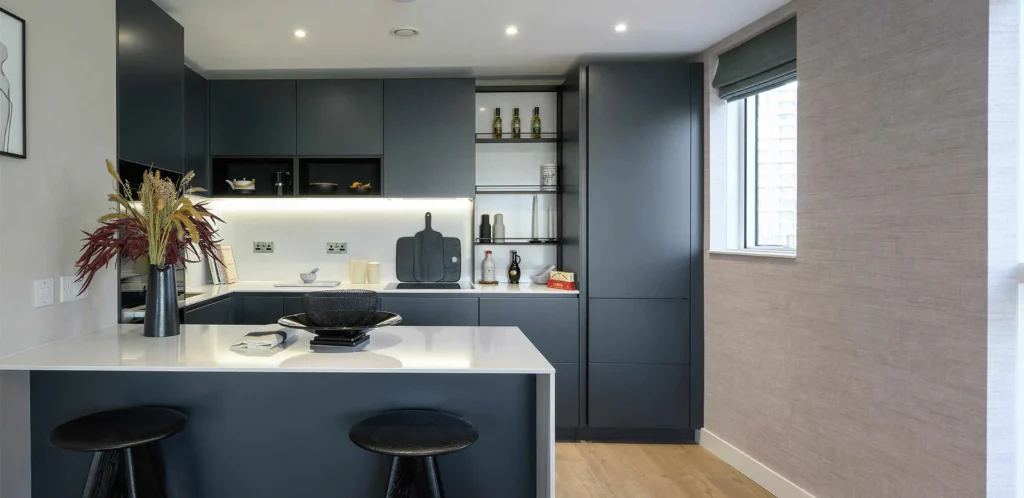 Berkeley Group - Dark Navy modern kitchen with waterfall white kitchen island.
